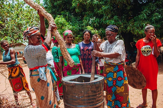 pexels photo 17902855 Group of women in colorful traditional clothing cooking outdoors.